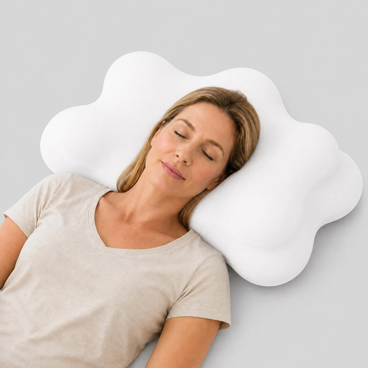 Woman sleeping on her back on the white CoveCradle Neck Align Pillow, head level in the shoulder channel